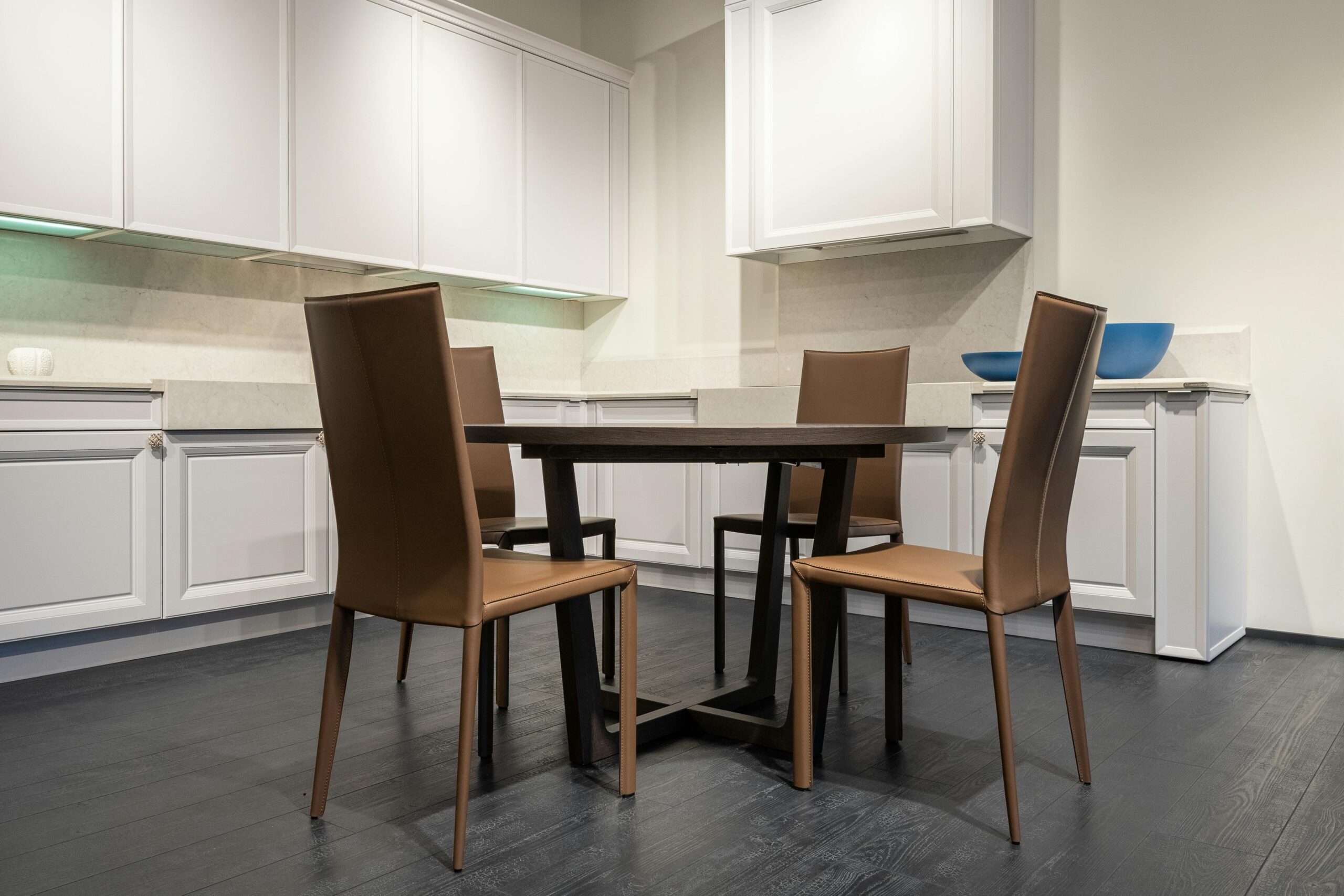 A contemporary kitchen featuring a modern dining set and minimalist cabinetry. Ideal for home and interior design inspiration.